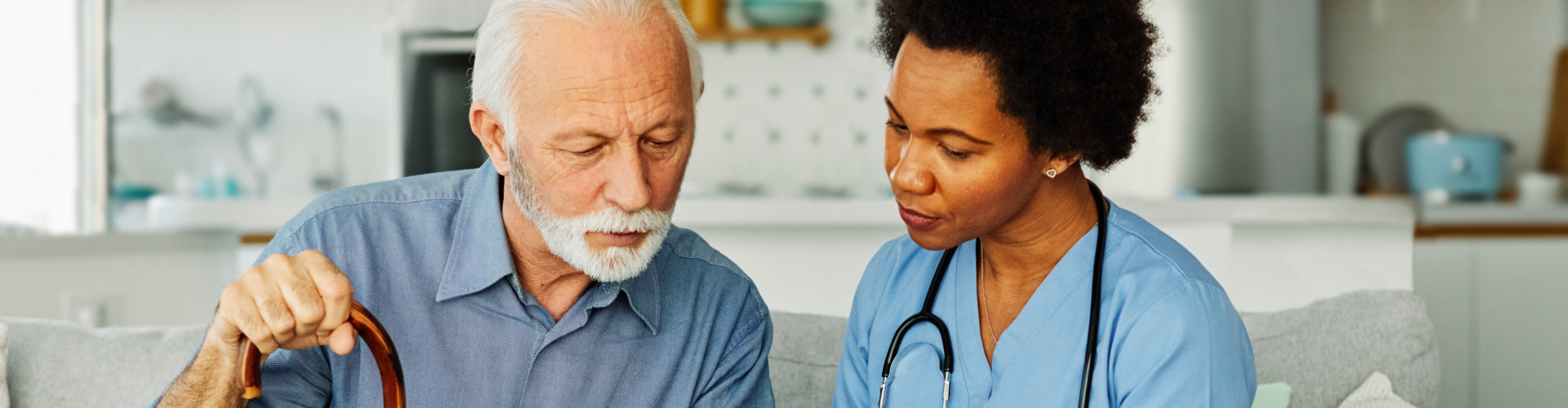 caregiver pointing at medical record of a man