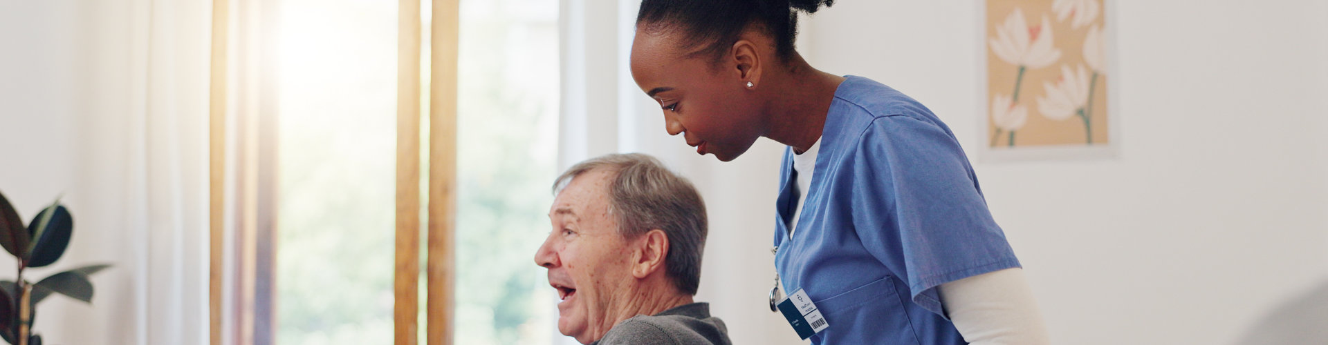 woman caregiver assisting elderly man